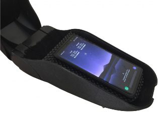 Qi-compatible smartphone wirelessly charging in an automobile armrest.